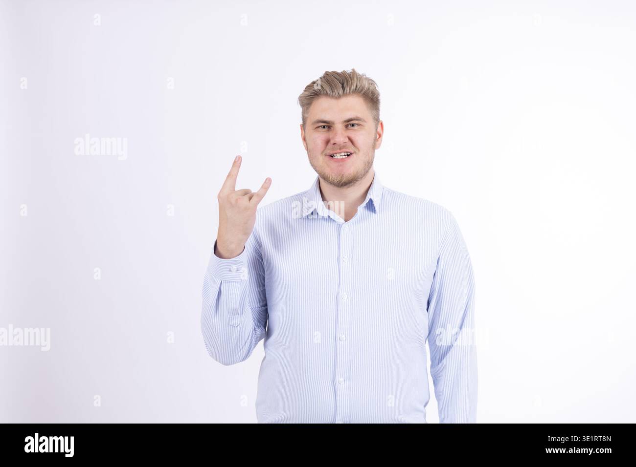 Man showing victory sign and smiling Stock Photo