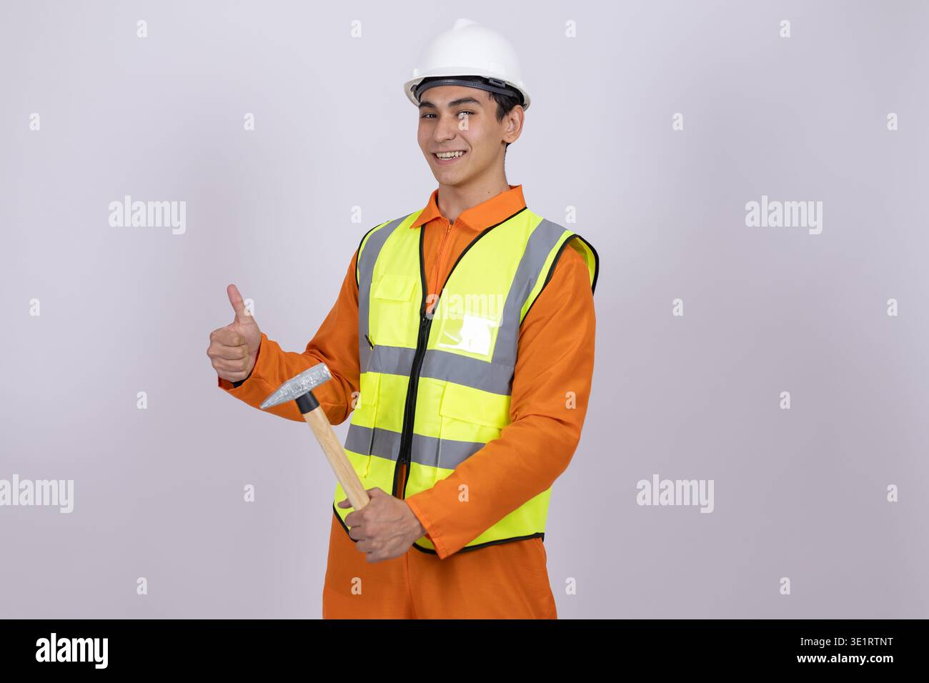 Worker in safety vest showing thumbs up gesture Stock Photo