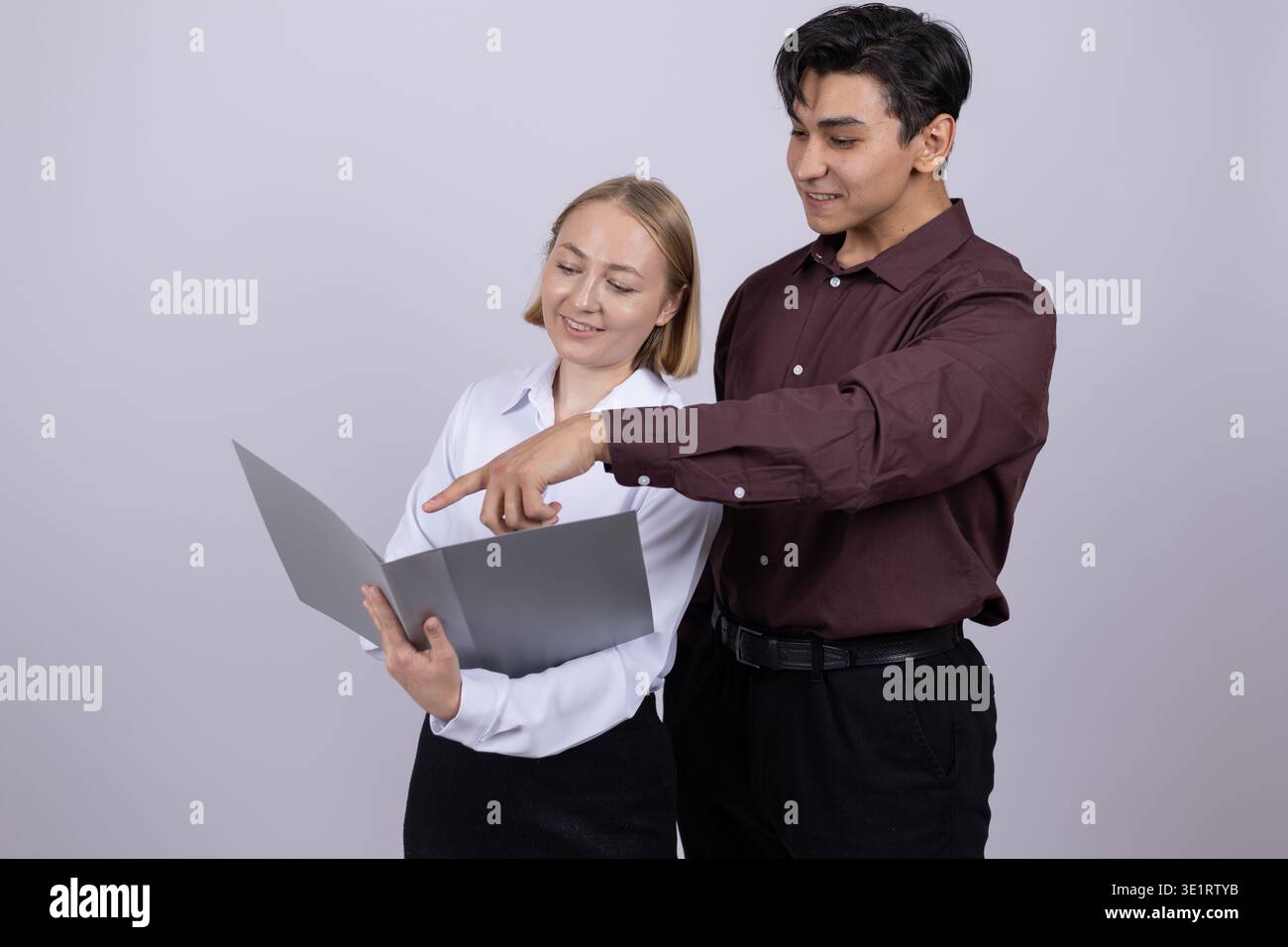 Man and woman checking documents in a folder Stock Photo