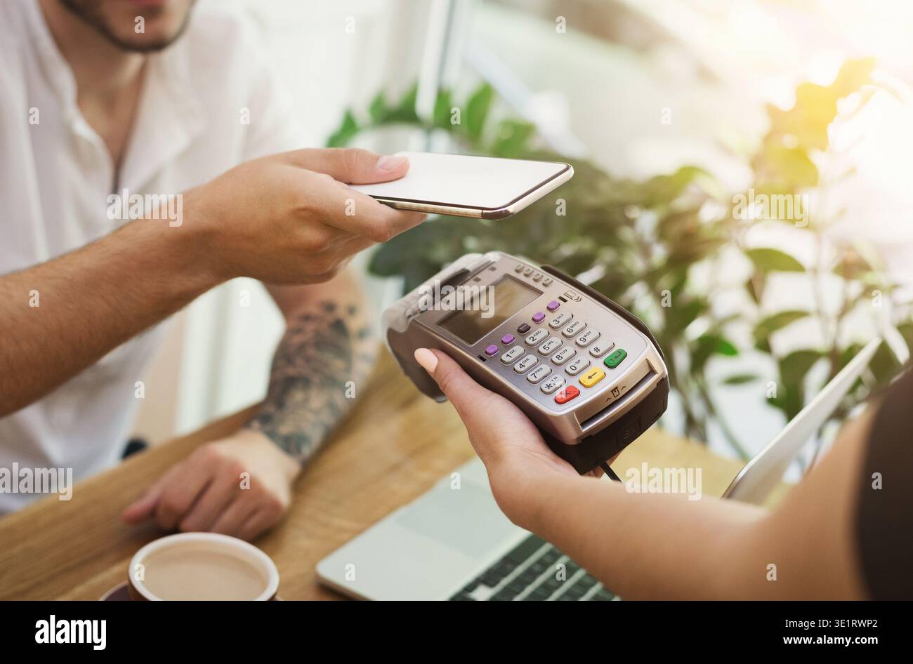 Man paying bill through smartphone using NFC technology Stock Photo