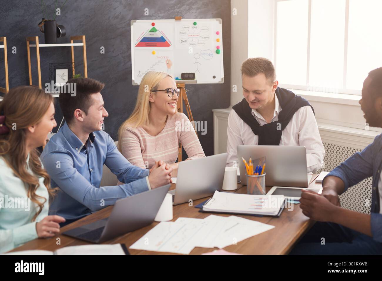 Young team discussing project in modern office Stock Photo