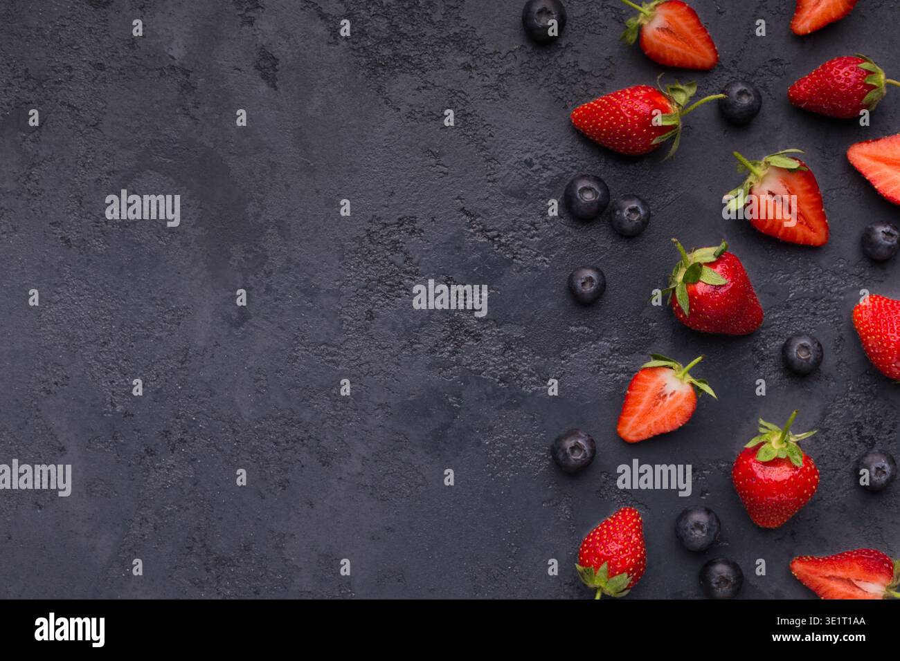 Blueberry and strawberry pattern on black background Stock Photo