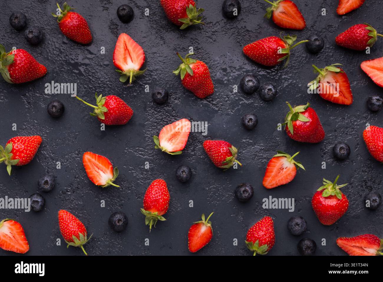 Blueberry and strawberry pattern on black background Stock Photo