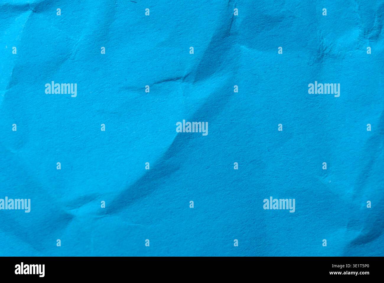 Smooth surface features elegant creases creating a lively blue backdrop. Stock Photo