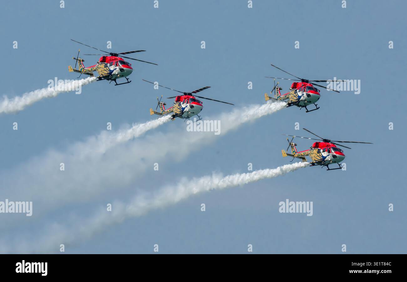 Aerial view of four helicopters in acrobatic display, soaring through ...