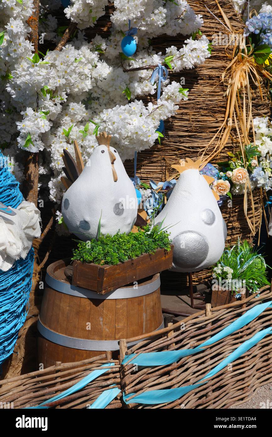 Decorative Easter egg display with white eggs and flowers in a rustic wooden setting. Stock Photo