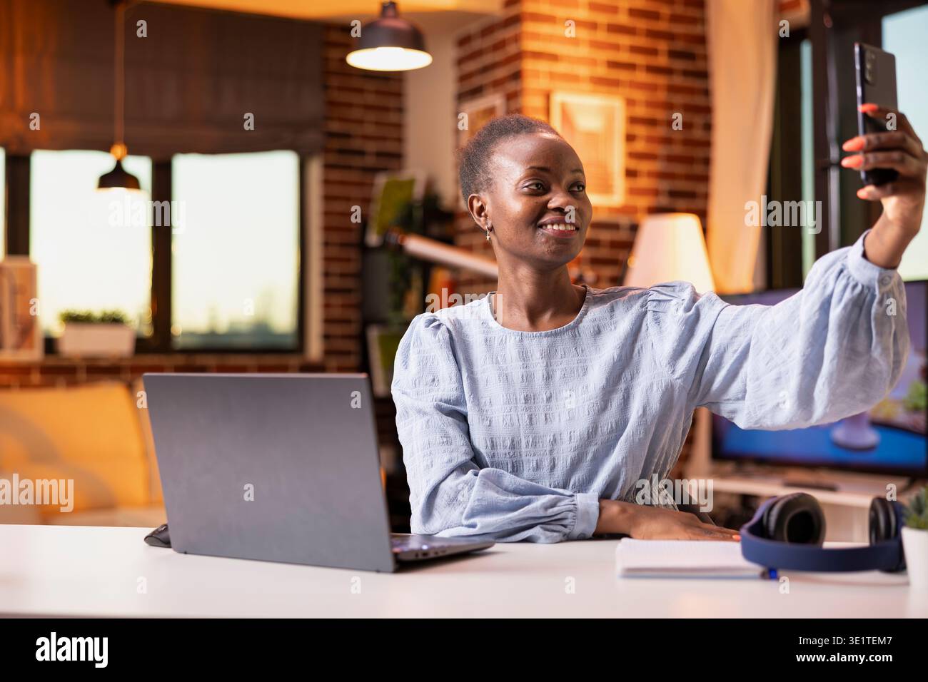 Woman raises smartphone cheerful selfie hi-res stock photography and ...