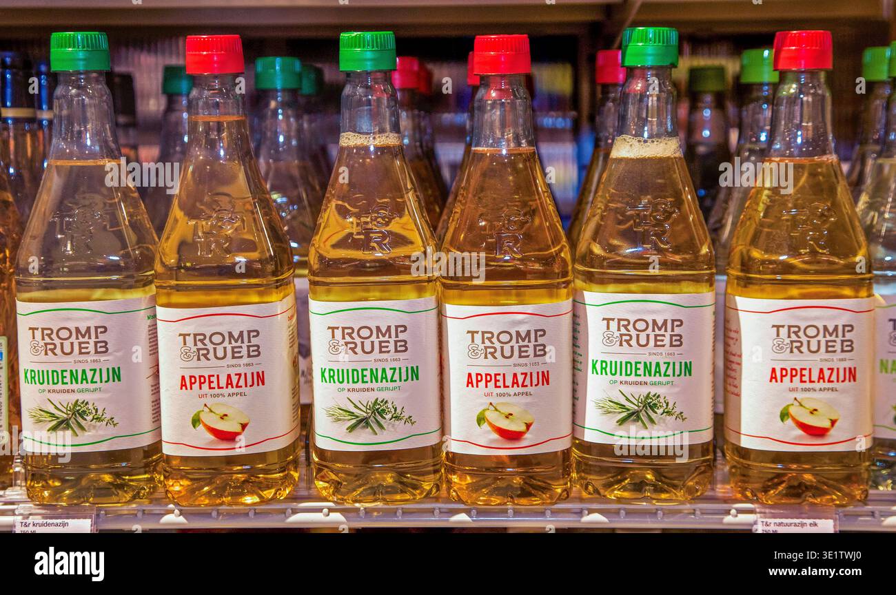Netherlands, bottles of apple cider vinegar and herbal vinegar on a supermarket shelf Stock Photo