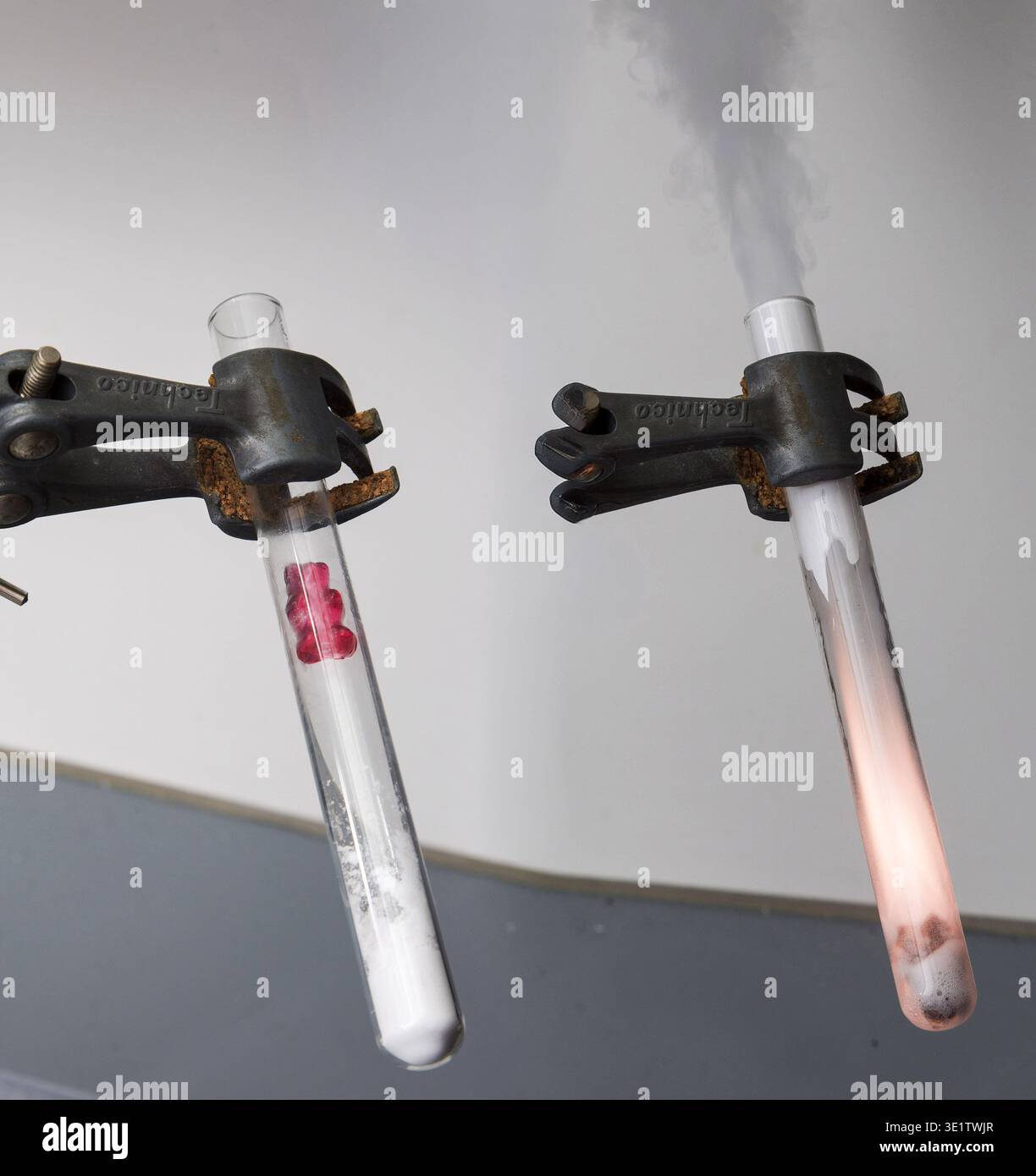 Potassium chlorate, KClO3 and wine gum in a test tube reacts quit violently. Stock Photo