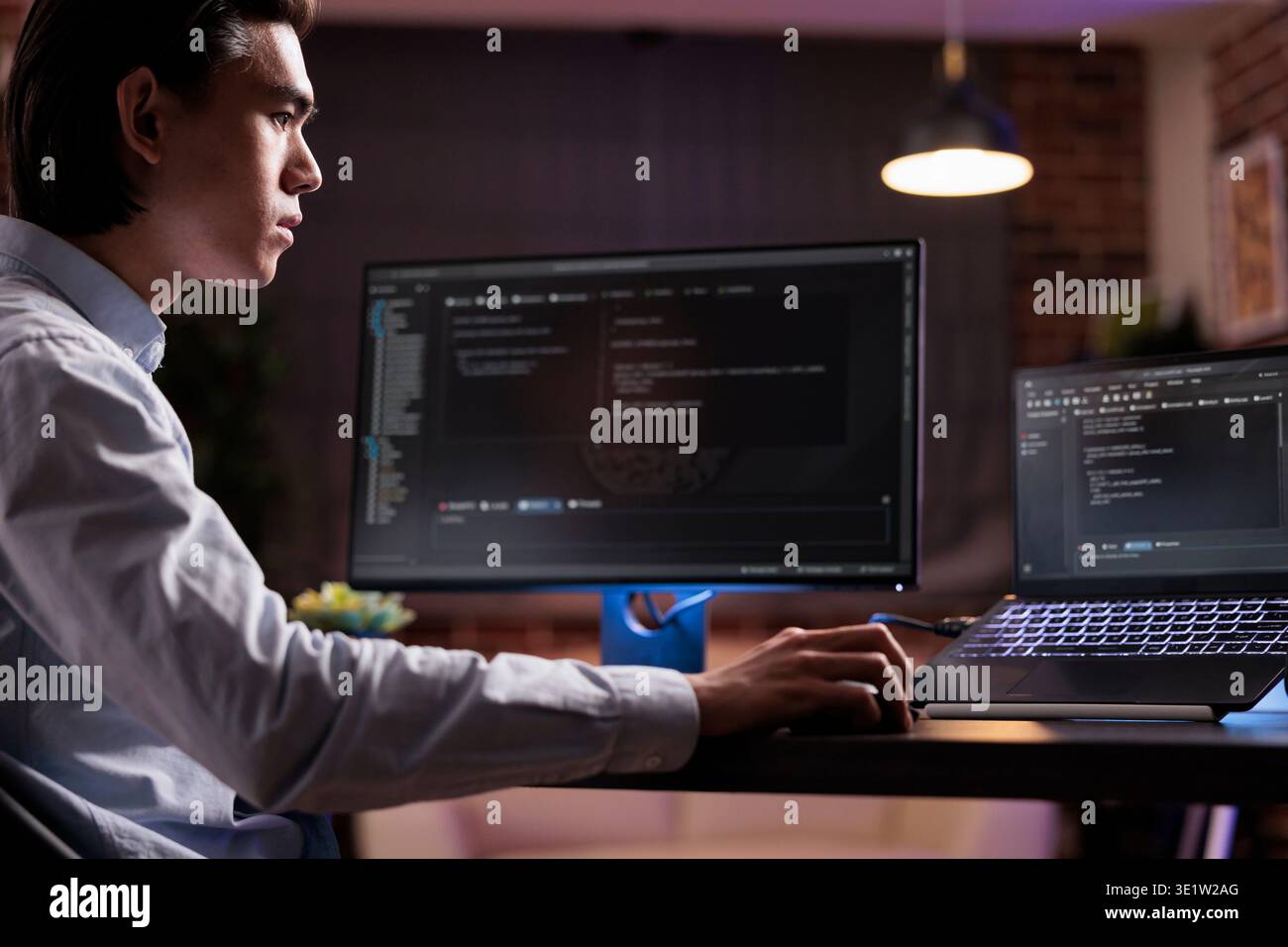 Software developer coding firewall program on monitor and laptop, using encryption server to script security network with binary code. Developing app on data text interface, it programming. Stock Photo