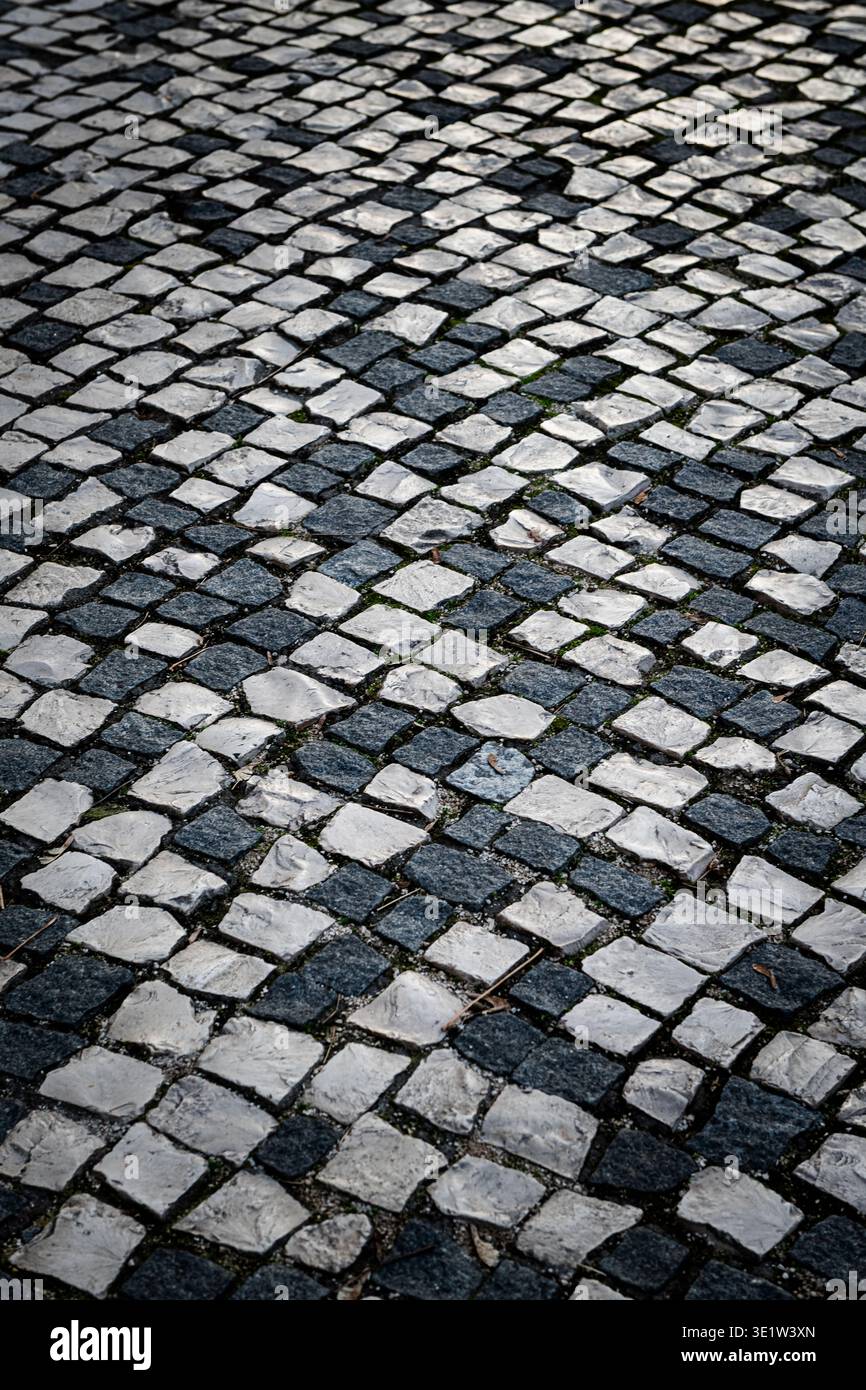 Black and white, checkered, patterned, abstract, square, cobblestone street pavement. Stock Photo