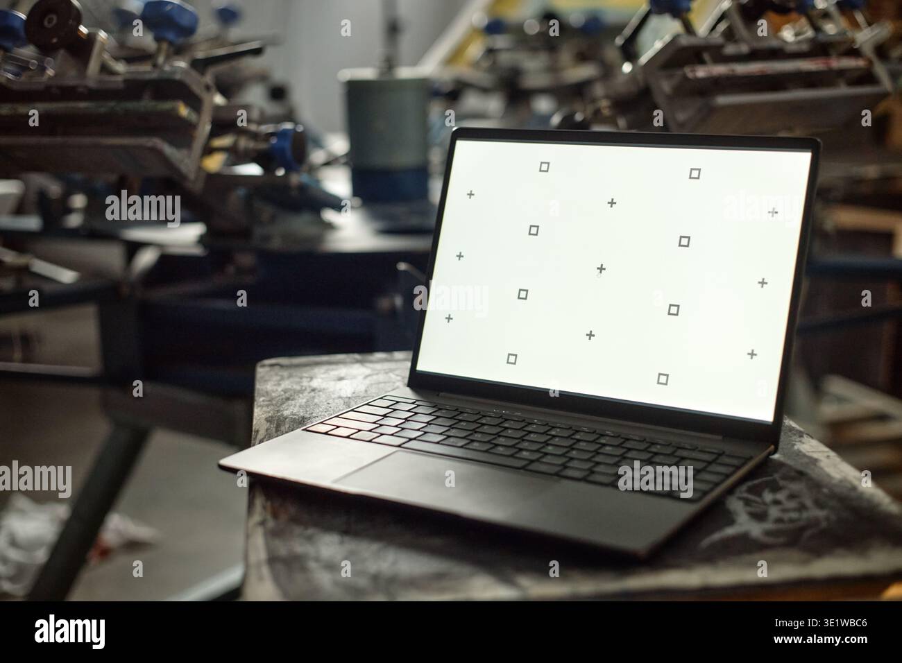 Laptop Computer Displaying Calibration Screen in Industrial Workshop Setting Stock Photo