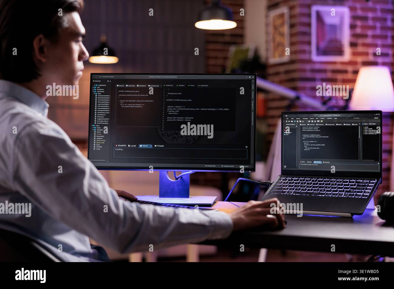 Male freelancer programming server encryption on firewall software, using security network interface to code system data for app development. Working with binary code text to script program. Stock Photo