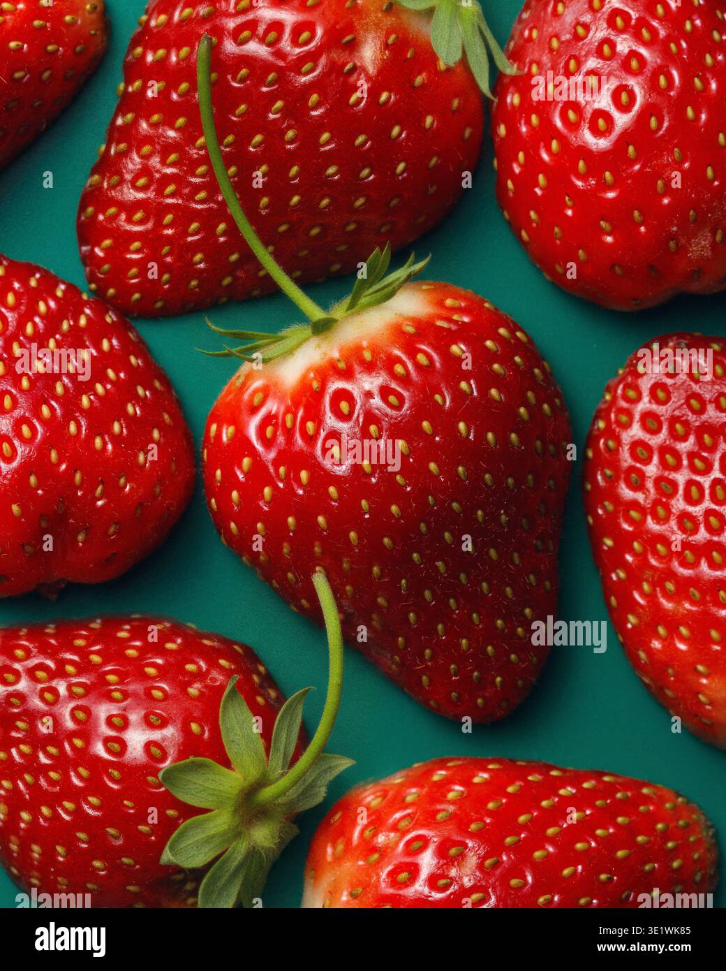 Fresh Strawberries Pattern on Teal Background Stock Photo