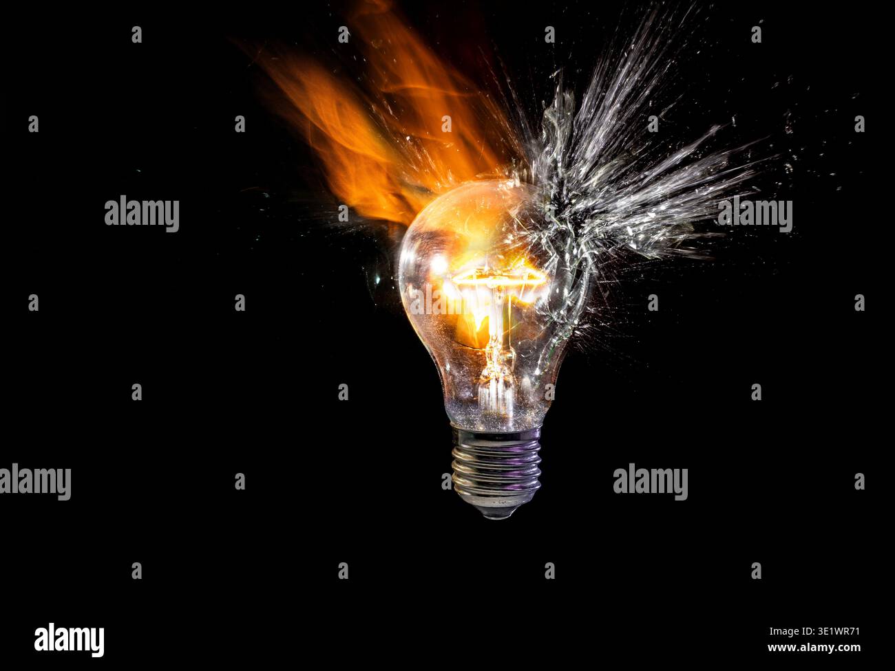 Real Light bulb exploding in a burst of fire Stock Photo