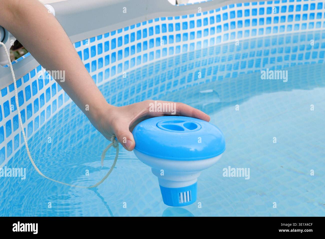 Pool Chloo Worker hands isinfection and chlorination of water in the pool ...
