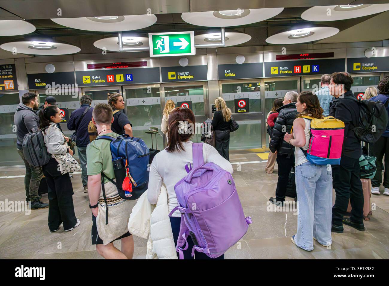 Madrid Spain,MAD Adolfo Suarez Madrid-Barajas Airport,inside interior terminal,exit sign Salida,gates sign Puertas H J K,baggage sign Equipajes,men wo Stock Photo