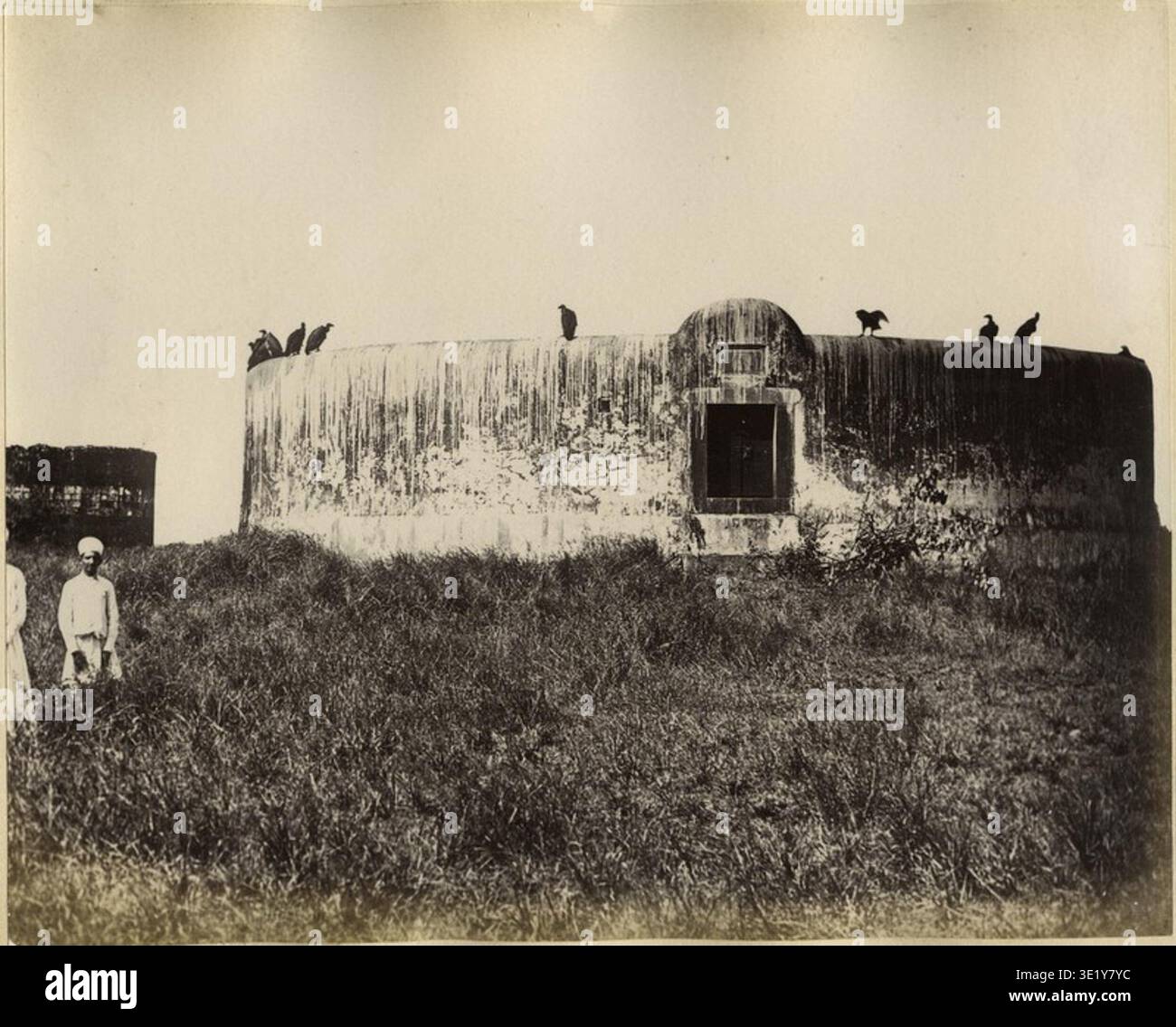 Bourne and Shepherd was a nineteenth-century photographic studio operating in India and known for producing documentary photographs of cities, monuments, and communities across the region. The archival photographic record documents an albumen photographic print titled "Parsee Tower of Silence, Bombay" dating from the 1880s showing the Zoroastrian funerary tower used by the Parsi community. Stock Photo