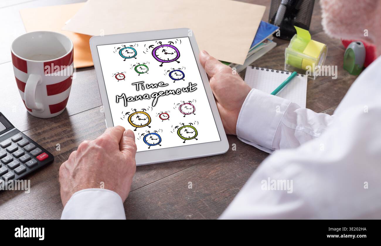 Time management concept shown on a tablet held by a man Stock Photo