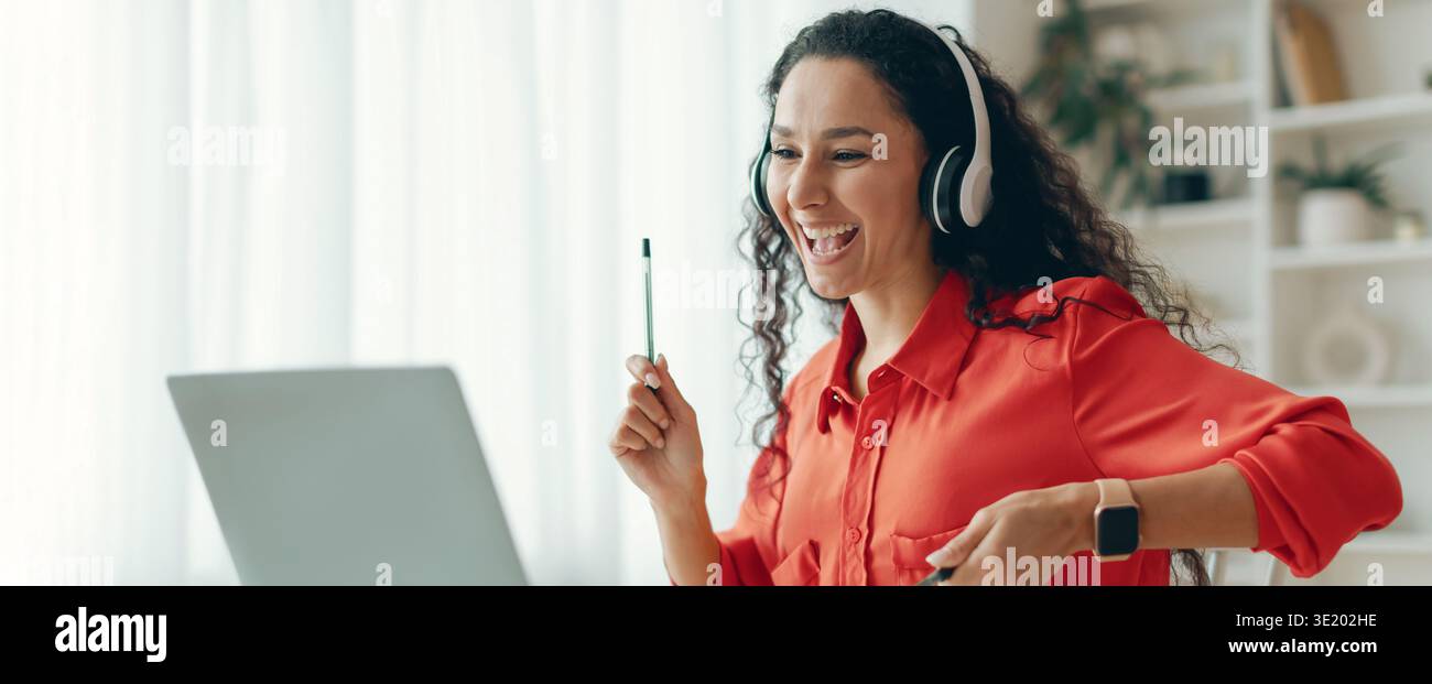 Woman Engaged in Virtual Learning With Excitement While Using a Laptop Stock Photo
