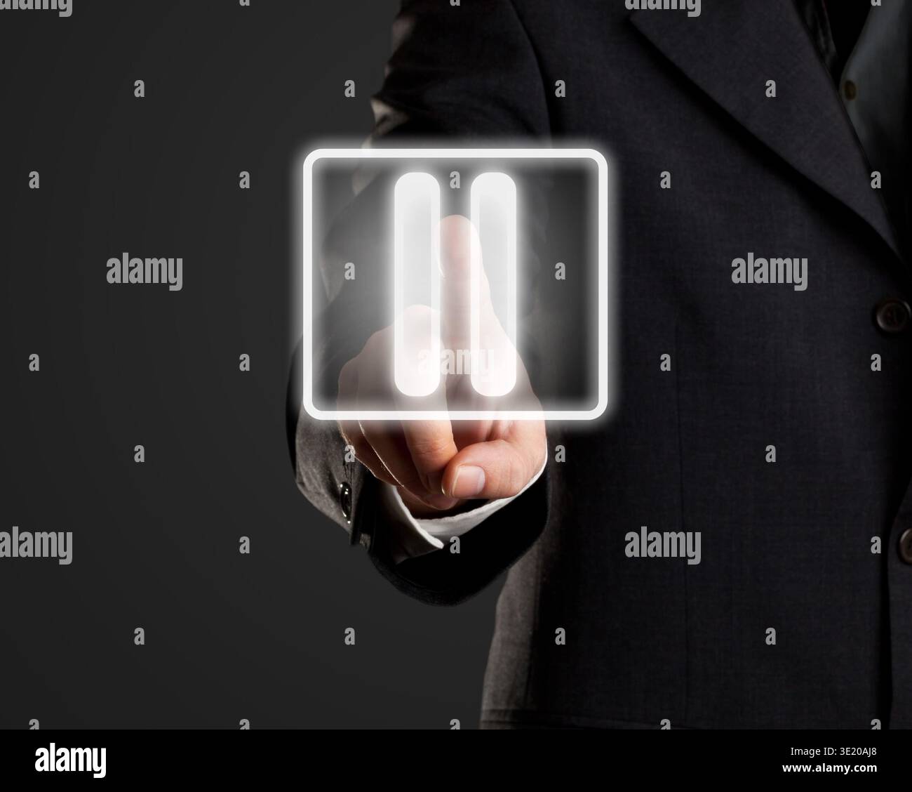 Businessman pressing pause button on virtual screen Stock Photo