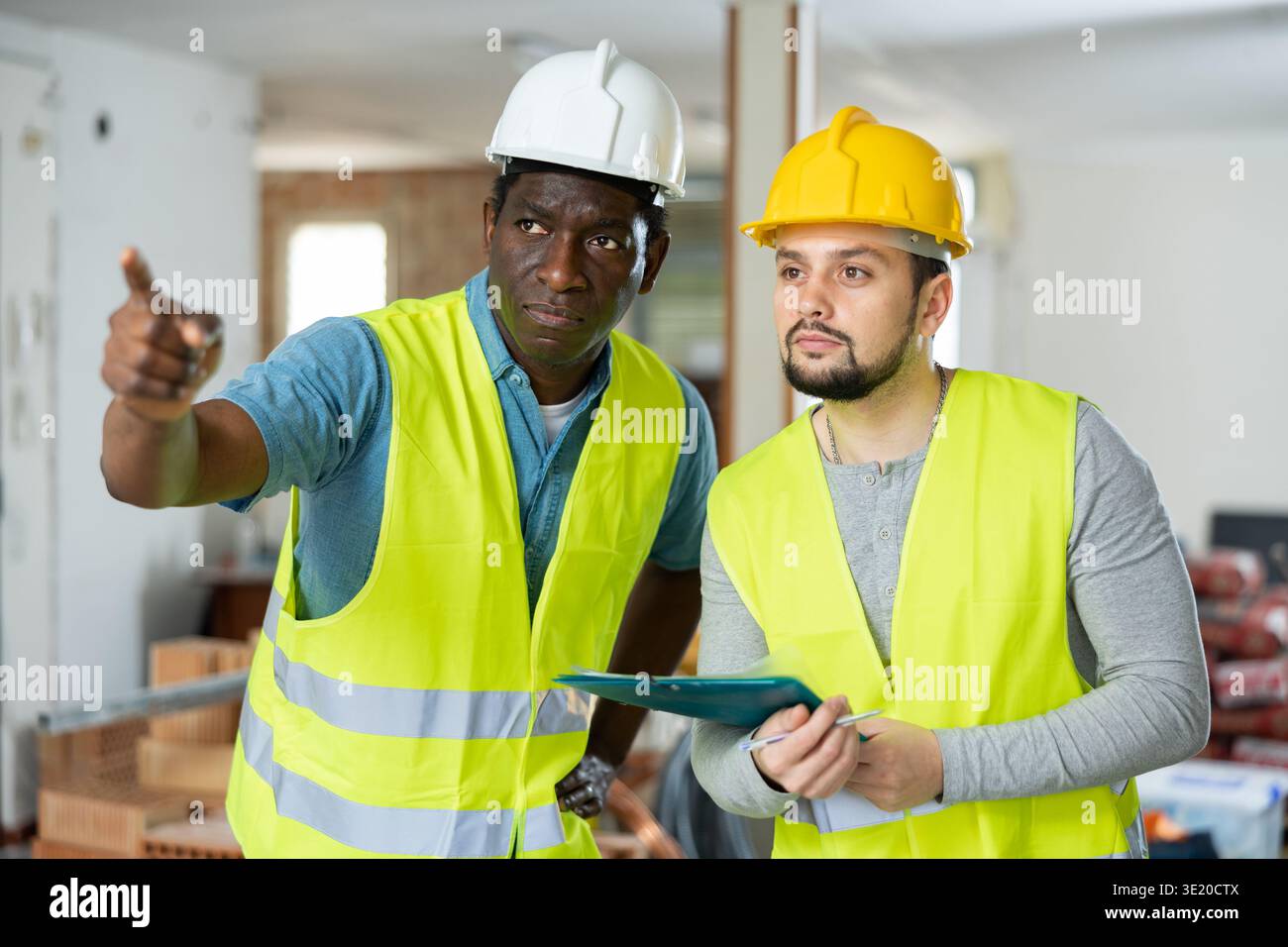 Two engineers discussing work in apartment Stock Photo