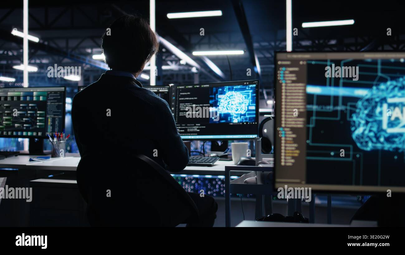 Data center engineer working on artificial intelligence neural network software development. Server hub IT professional implementing machine learning technology in workplace, camera A Stock Photo