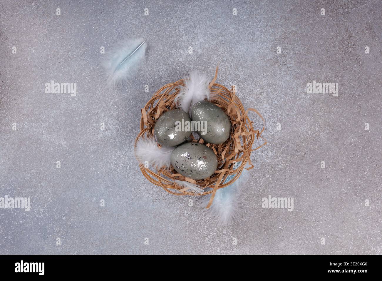 Easter eggs with silver texture in rustic nest top view Stock Photo