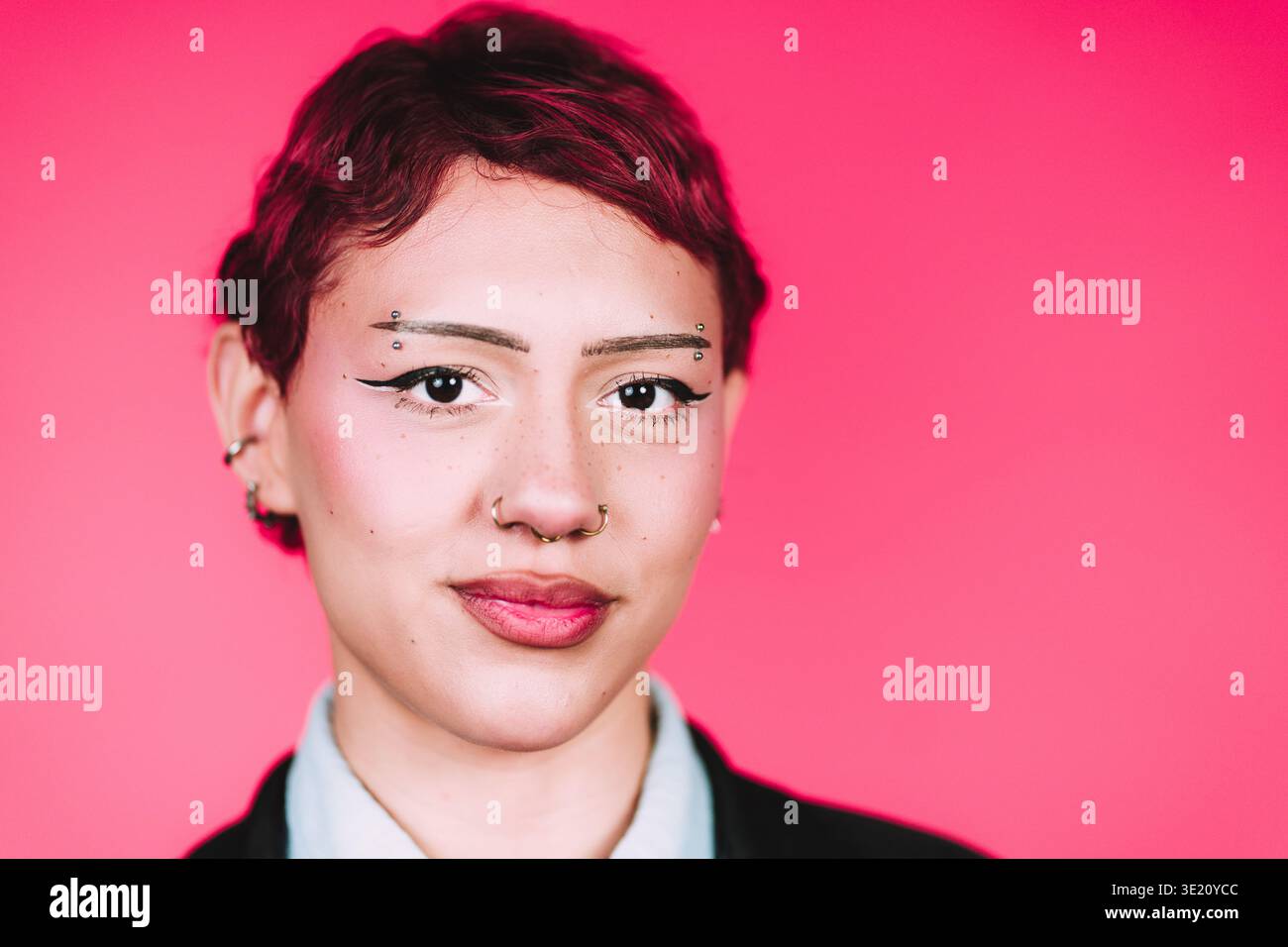 Young woman confidently posing with unique style Stock Photo