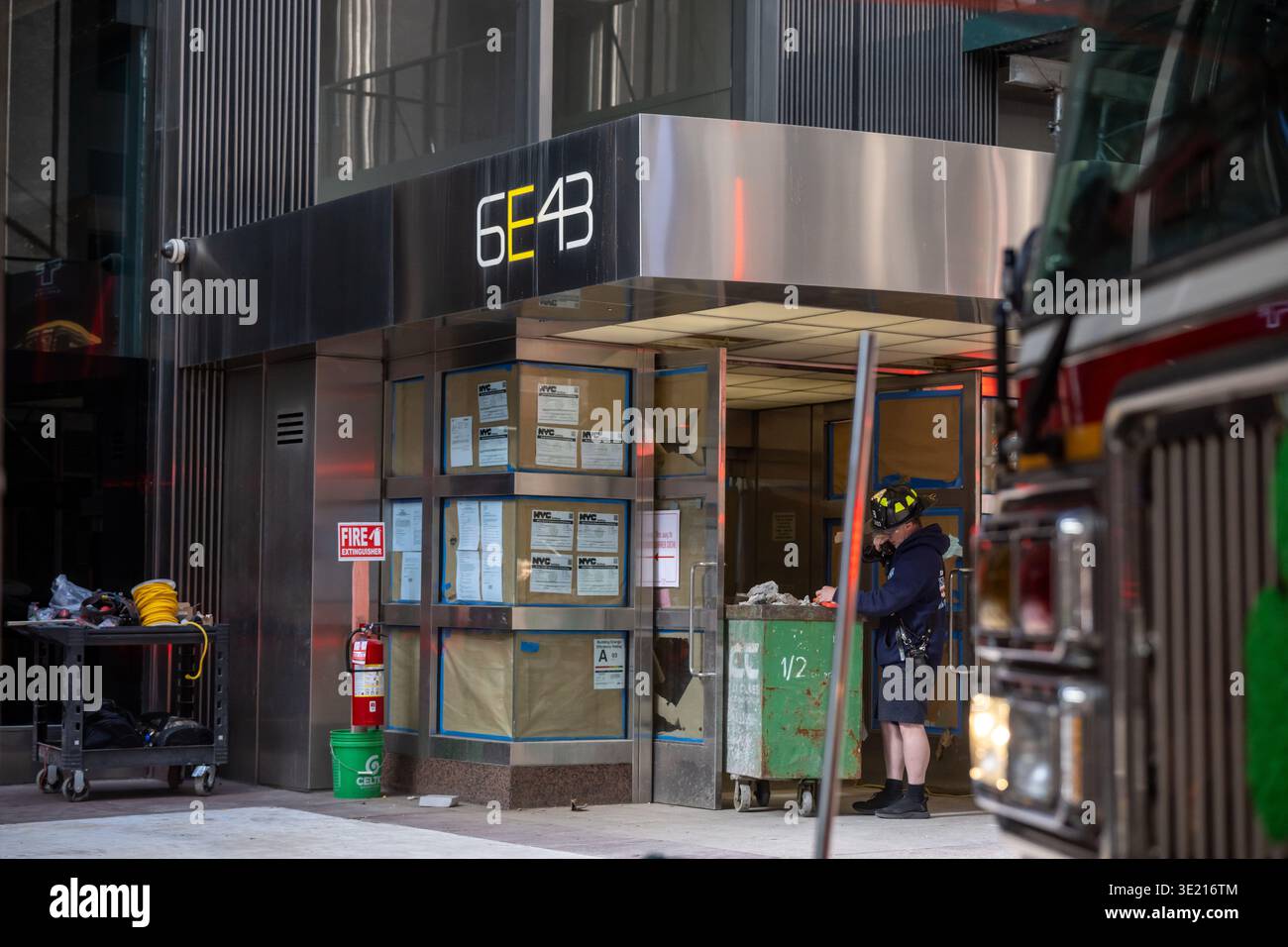 A Firefighter stands at the entrance to 6 East 43rd Street the site of ...