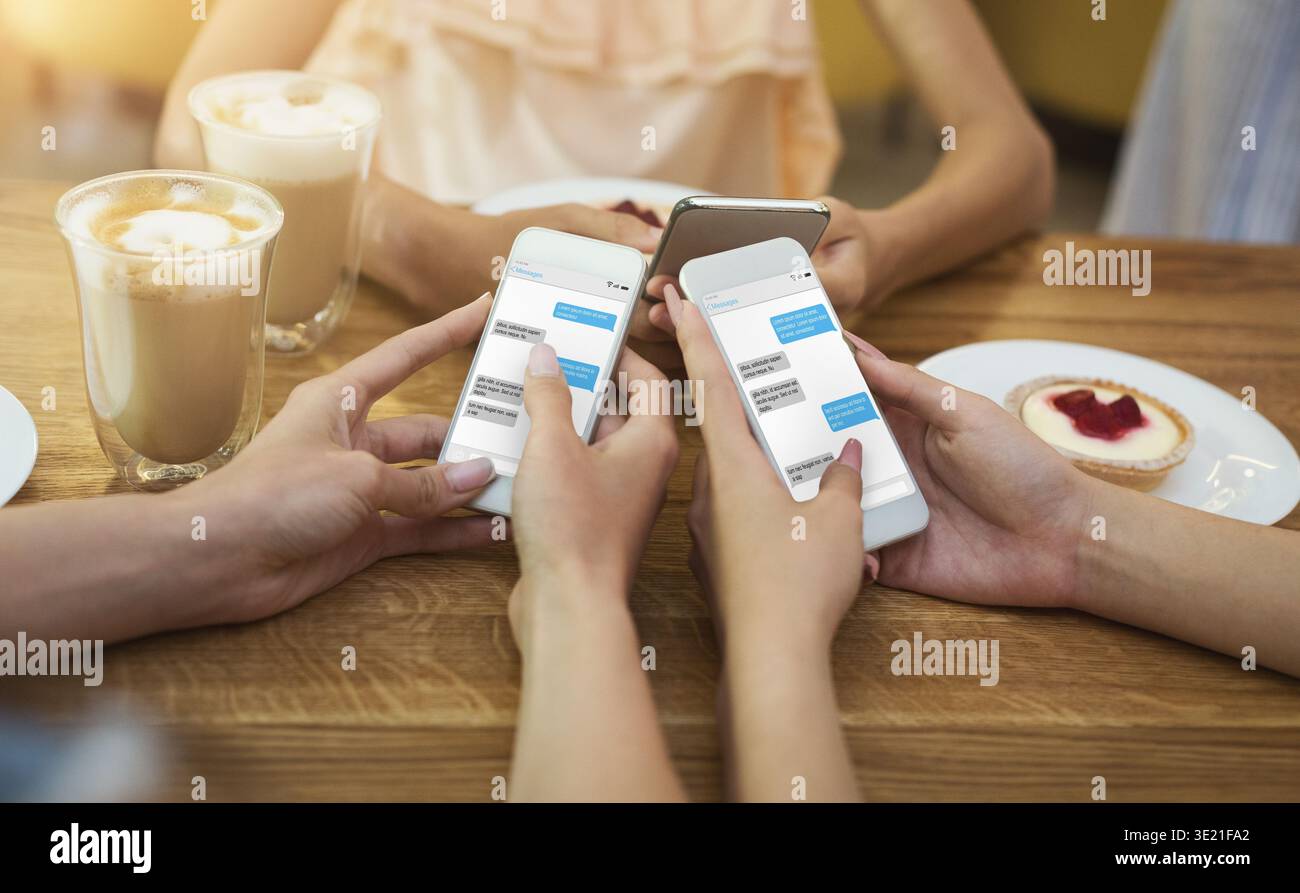 Friends texting on their smartphones Stock Photo
