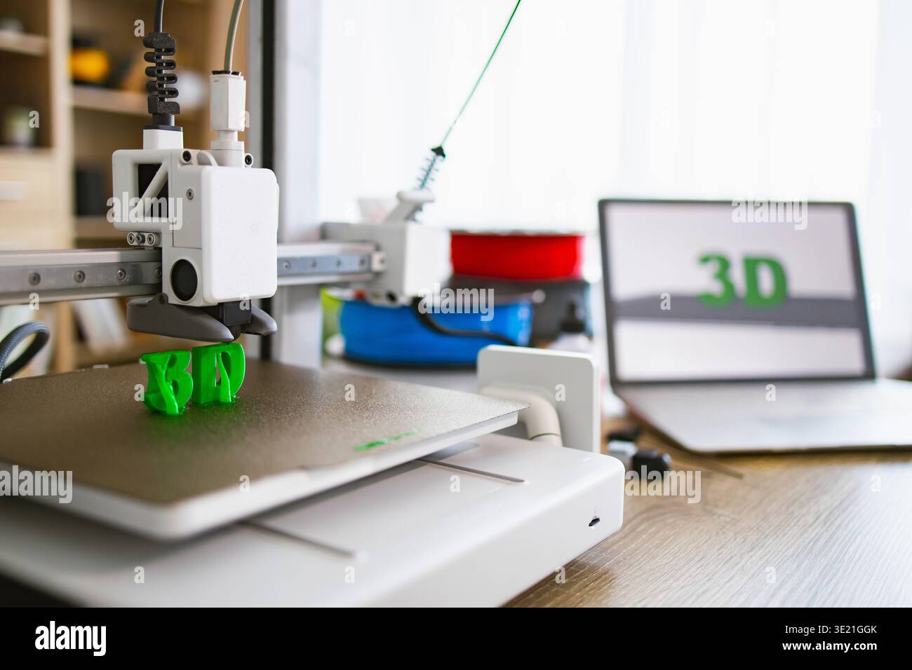 3D Printer Creating Green Letters Stock Photo
