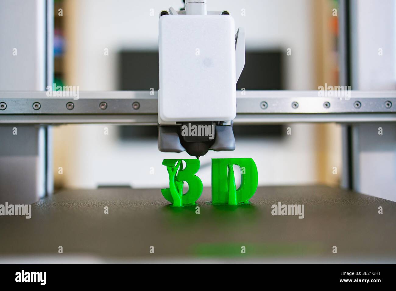 3D Printer Creating Green Letters Stock Photo