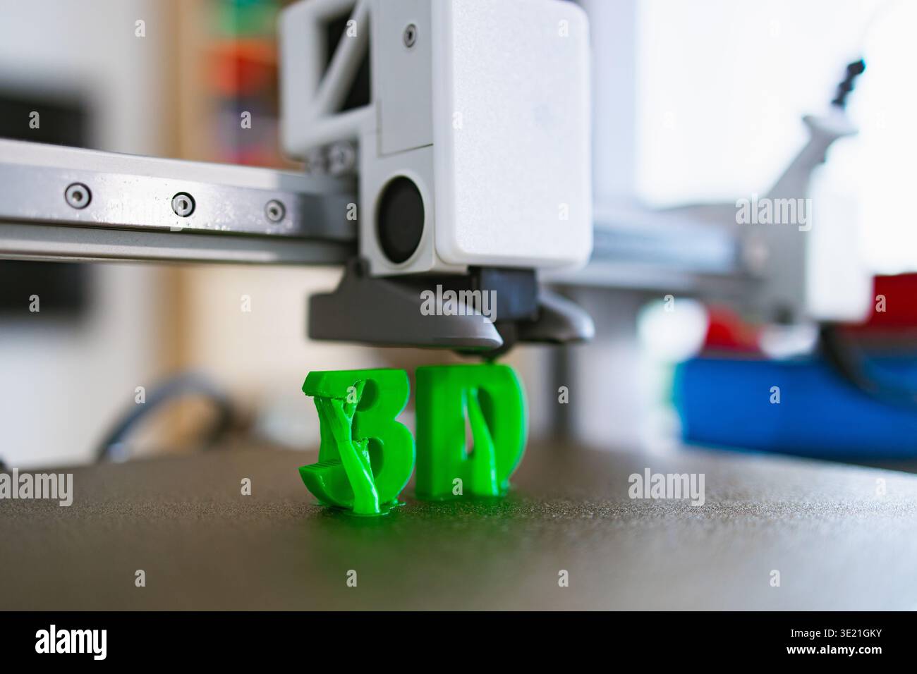 3D Printer Creating Green Letters Stock Photo