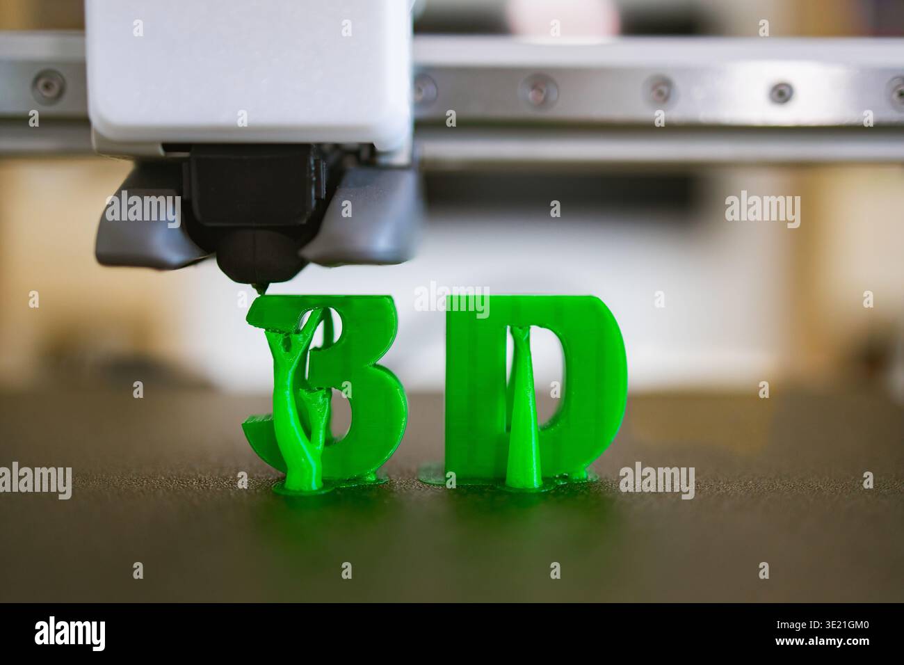 3D Printer Creating Green Letters Stock Photo