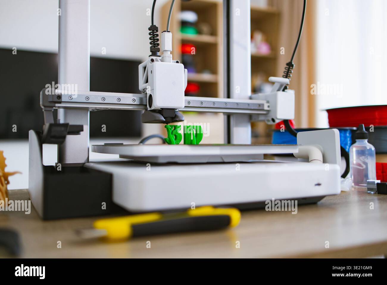3D Printer Creating Green Letters Stock Photo