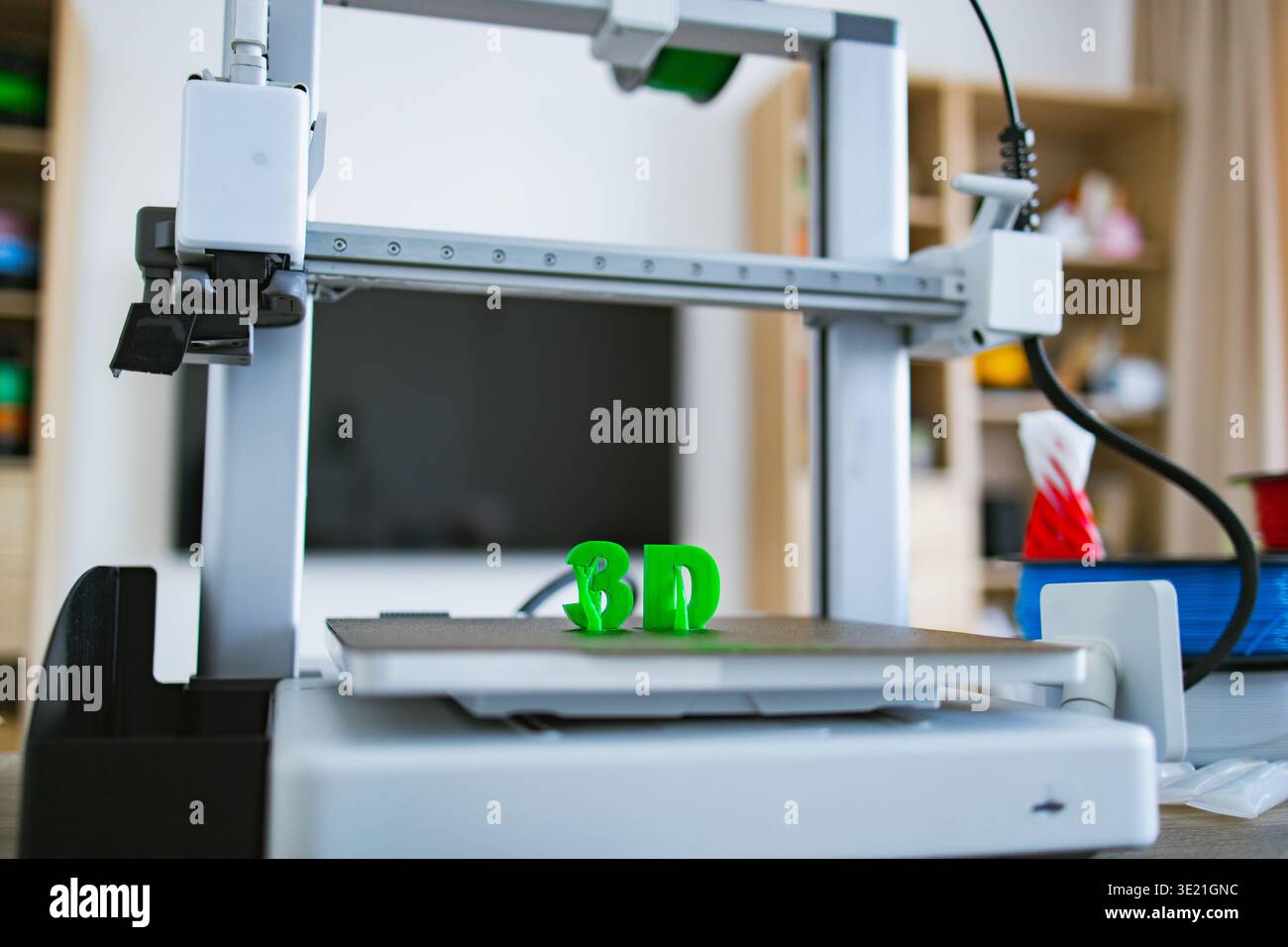 3D Printer Creating Green Letters Stock Photo