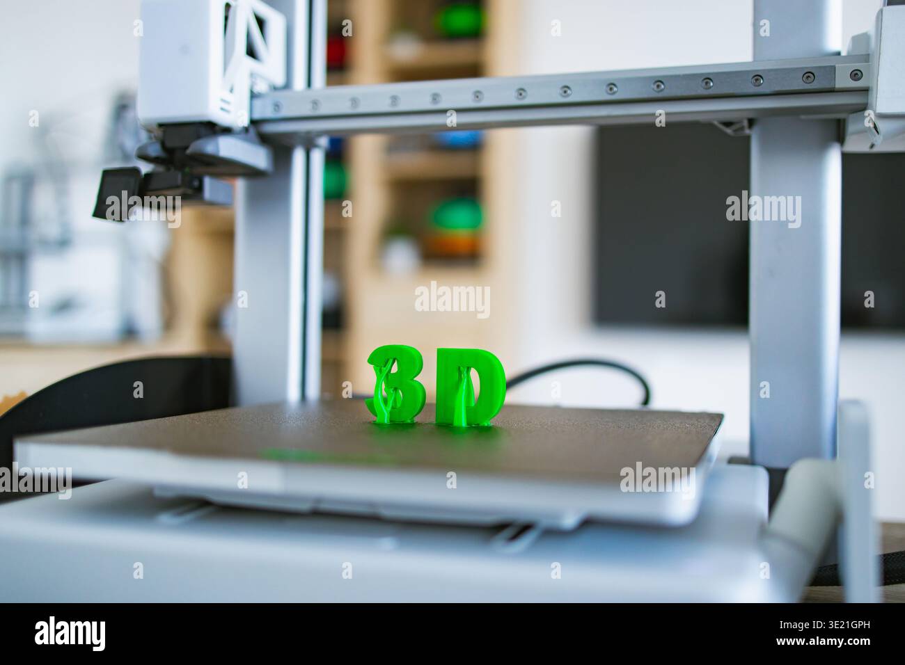3D Printer Creating Green Letters Stock Photo