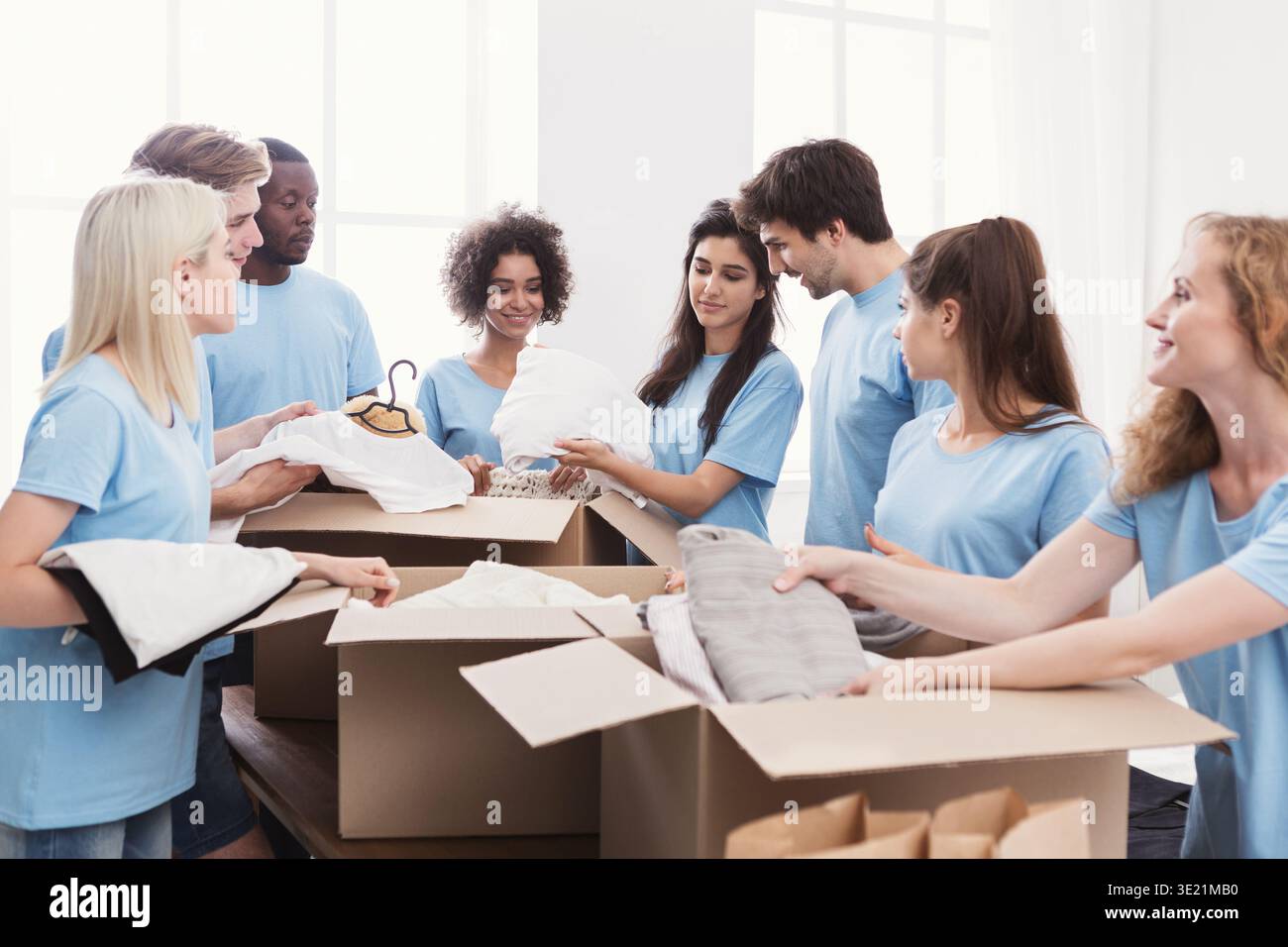 Young volunteers group working with clothing donation Stock Photo
