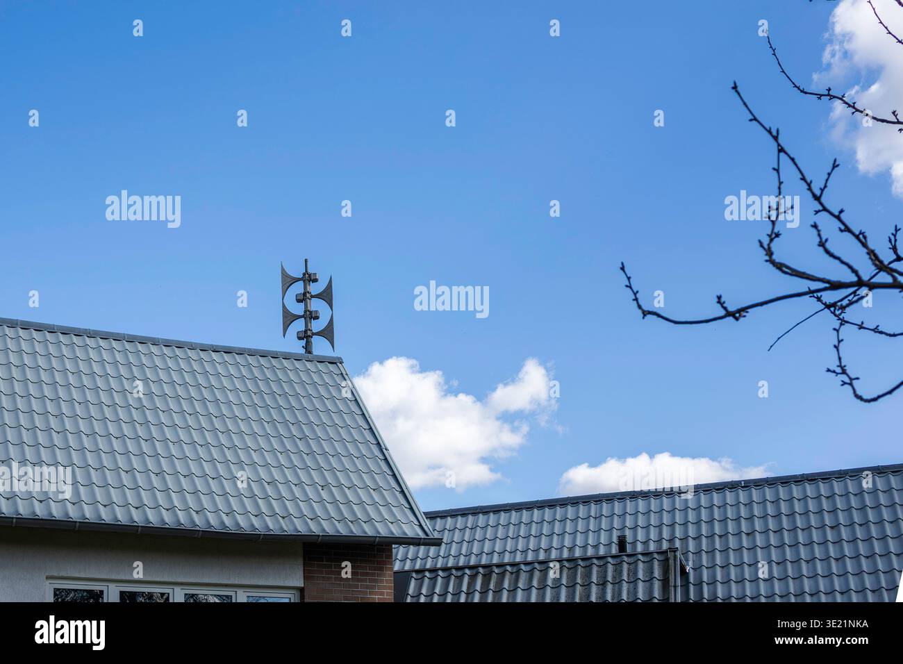 Sirens on a rooftop against a blue sky Stock Photo