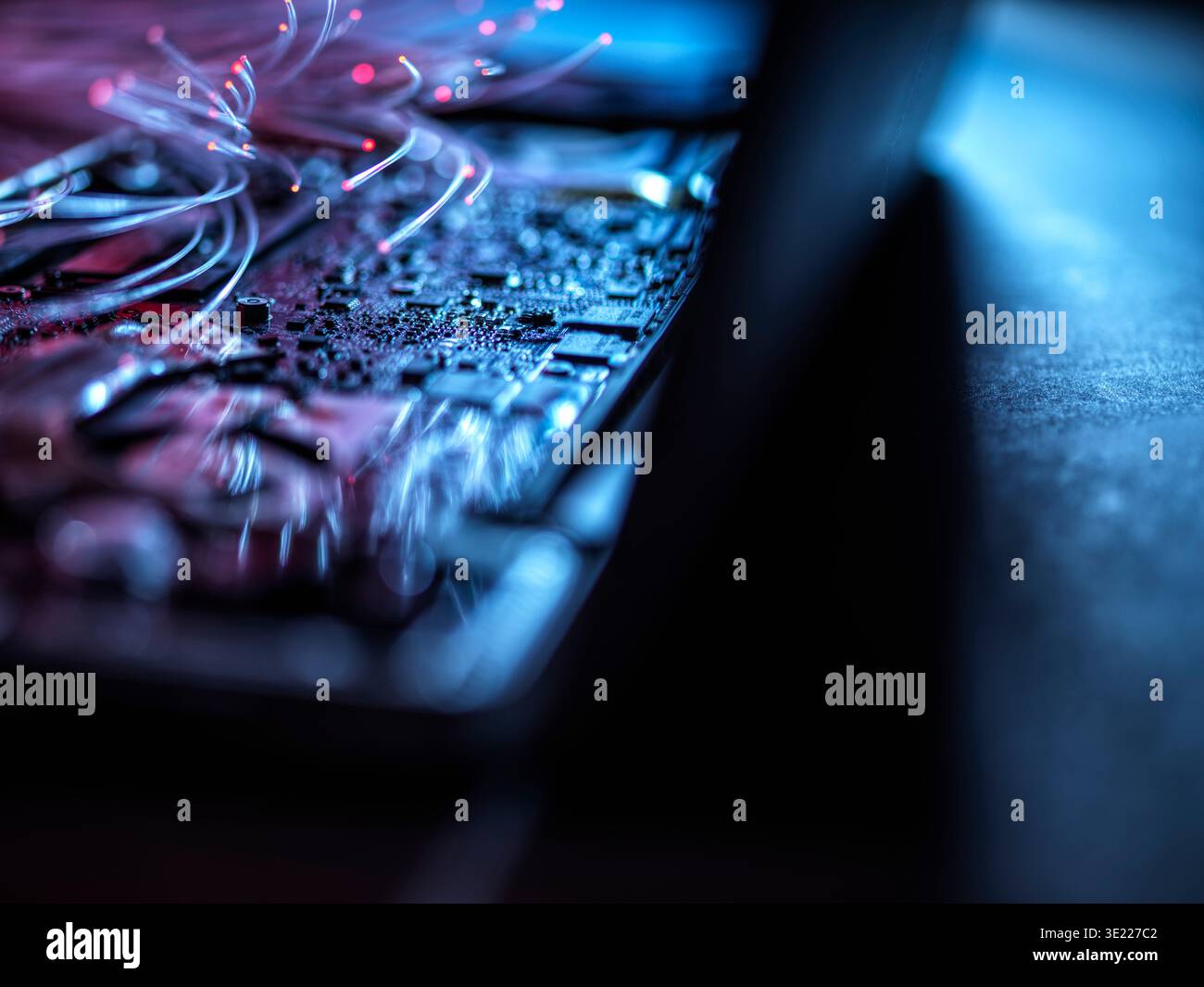 Fibre optics carrying data into a laptop computer Stock Photo