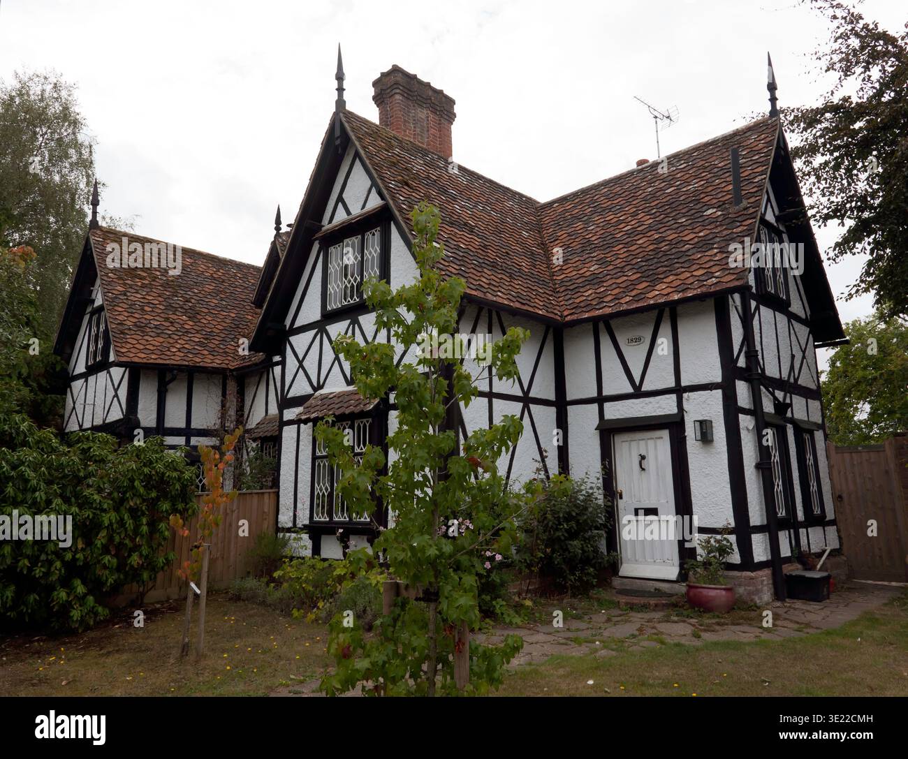 A  1829, House in Brockenhurst with a distinctive Tudor‑revival look, with steep gables, half‑timbering, and leaded windows. Stock Photo