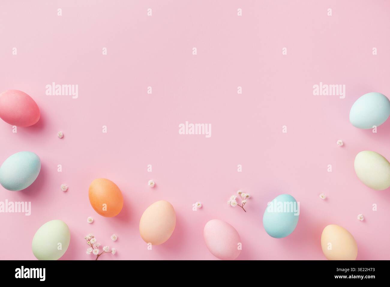 Pastel Easter eggs on pink background top view. Flat lay style. Stock Photo