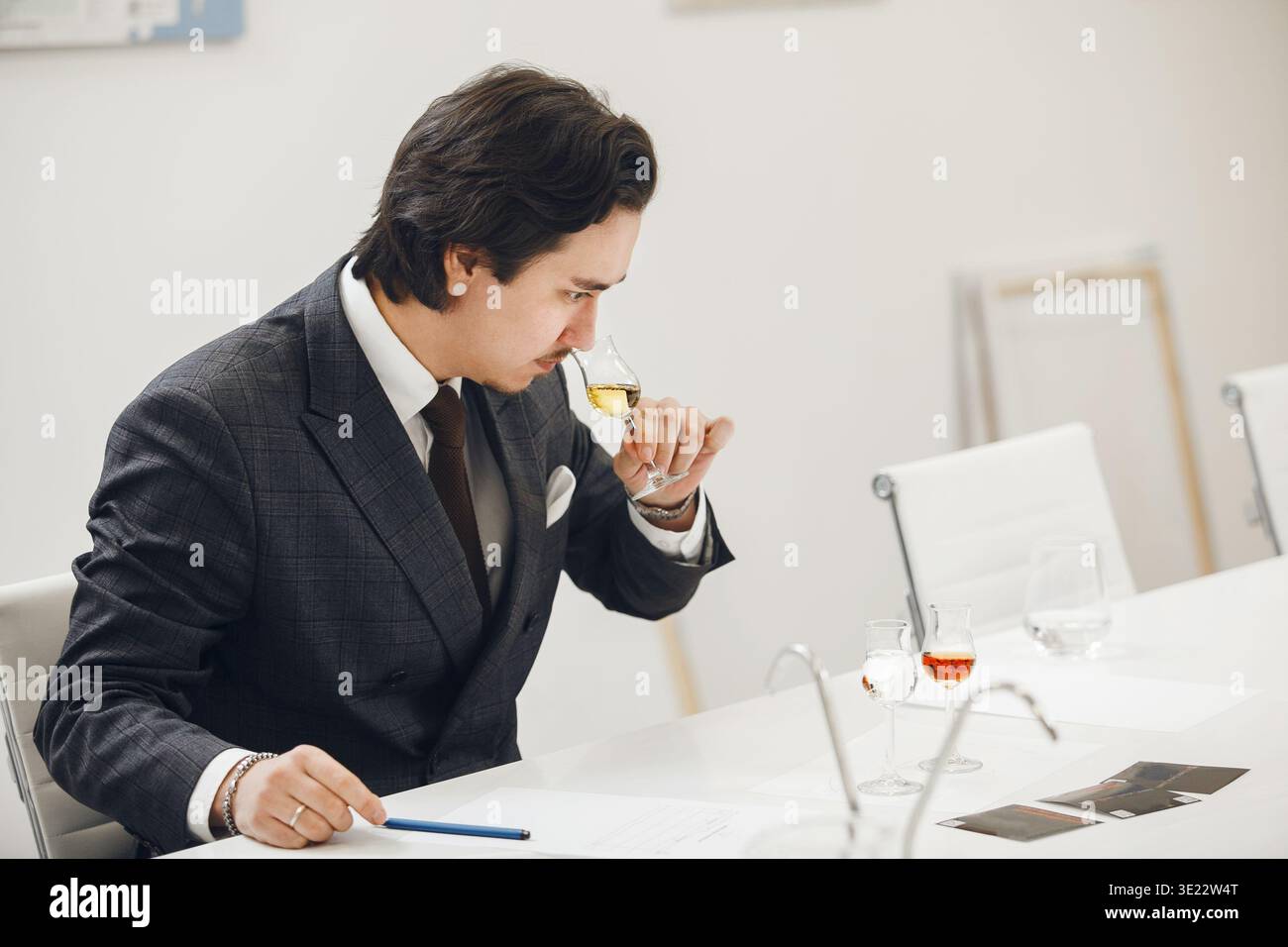 Sommelier Tasting Untitled Whiskey and Trying to Guess Name of Manufacturer during Training to Improve the Skills of Experts in Field of Alcoholic Stock Photo