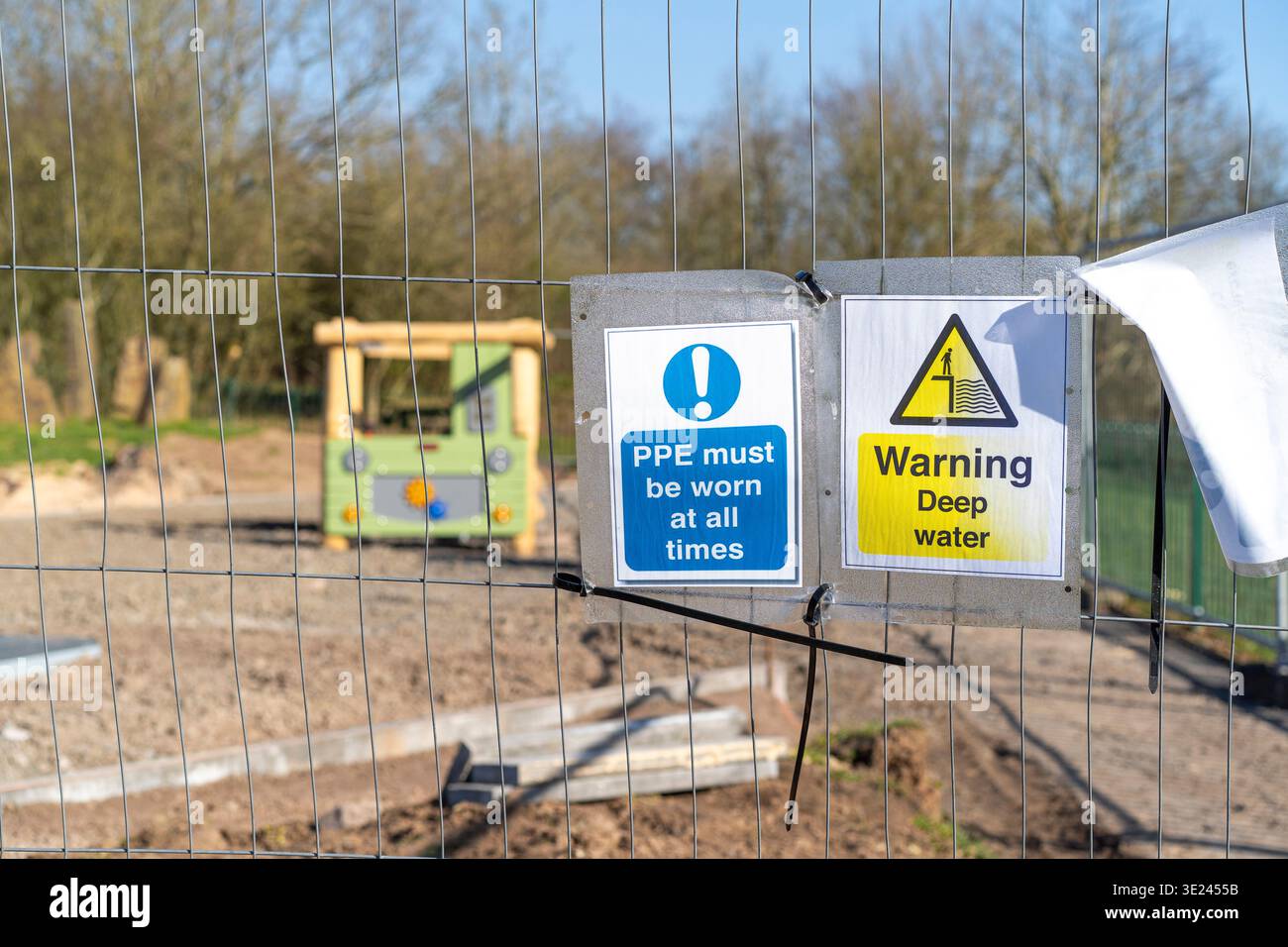 Construction site, warning deep water sign and PPE must be worn at all ...