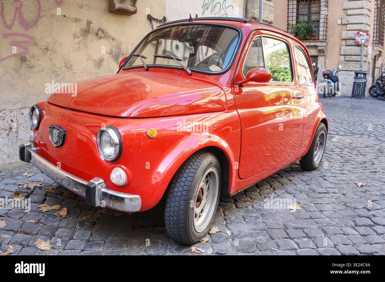 classic red fiat 500 micro car parked on cobbled street rome Centro ...