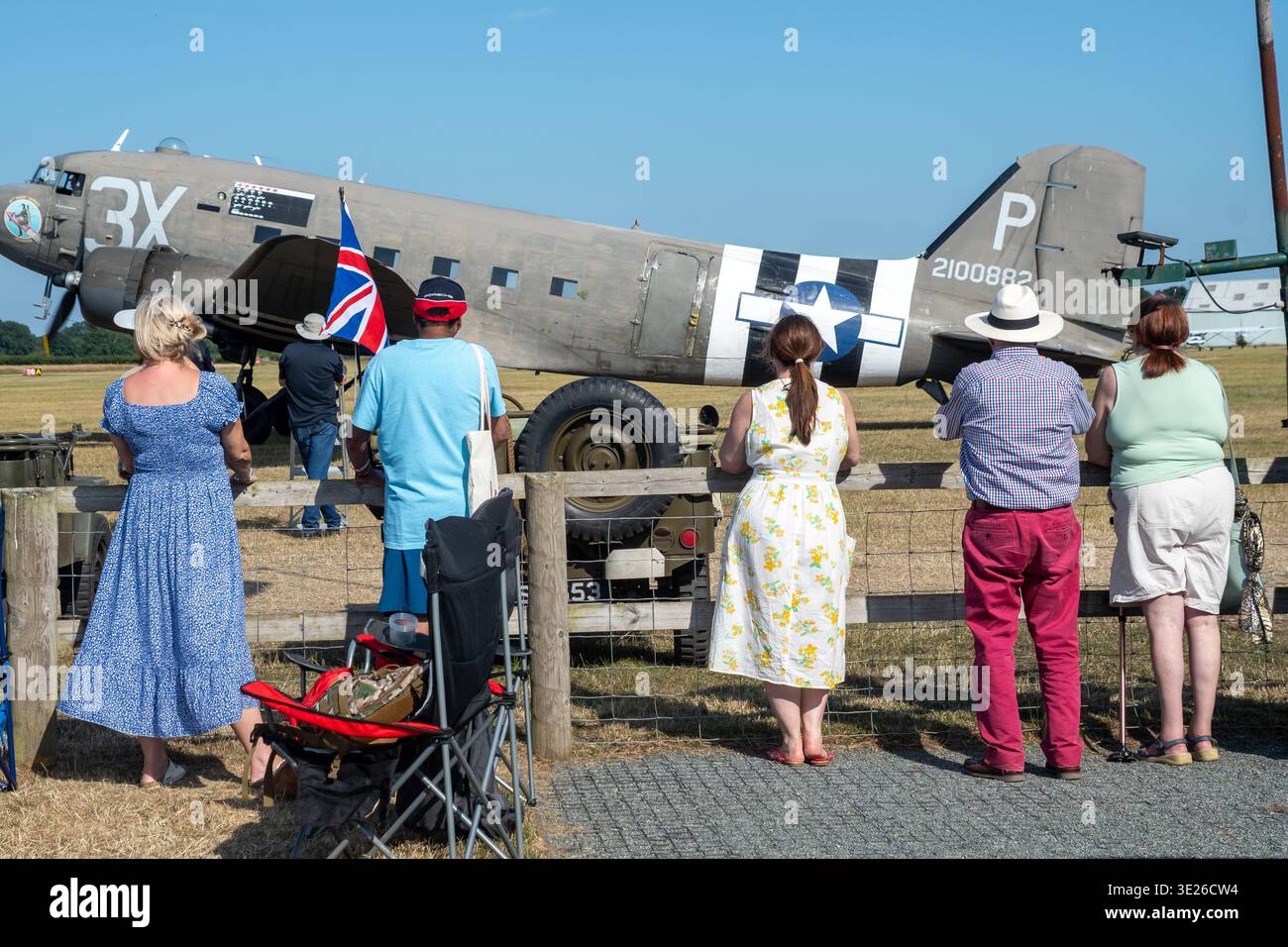 Headcorn Battle of Britain Airshow - Spectators lean on a fence to ...