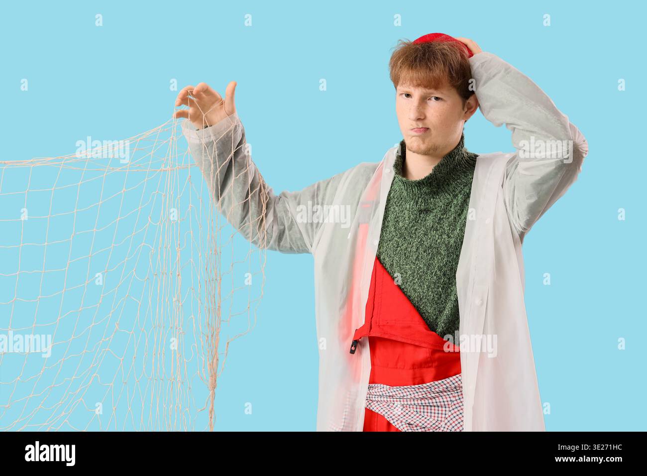 Funny young man with fishnet on blue background Stock Photo