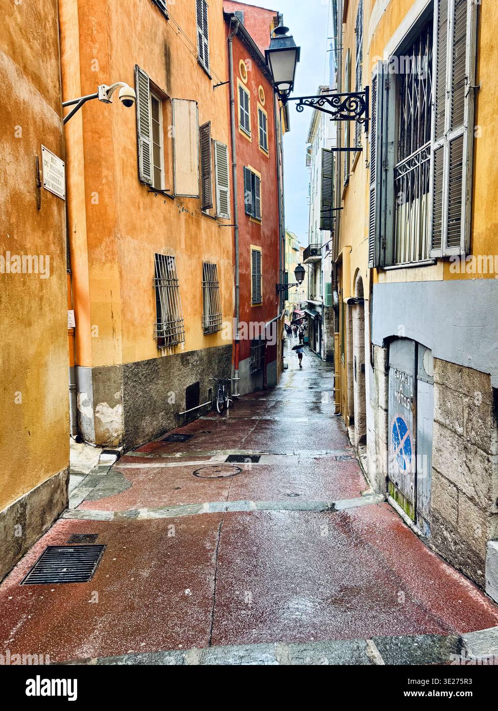 Light rain in Alley of Vieux Nice the city’s old town  (Vieille Ville) ; Nice France;French Riviera (Cote d'Azur) - Smartphone Captured Stock Image