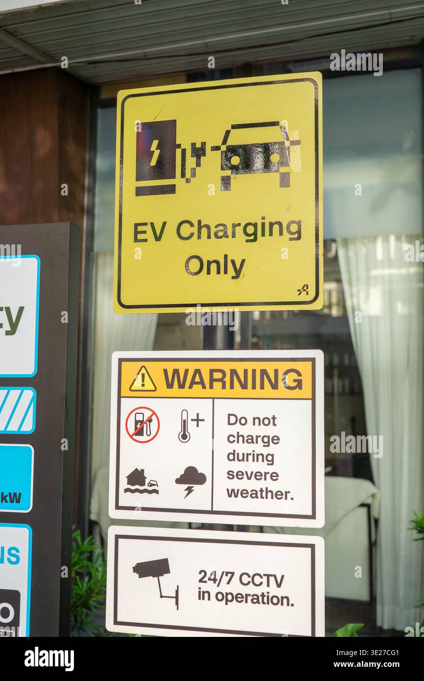Electric vehicle charging only sign with safety warnings at EV charging ...